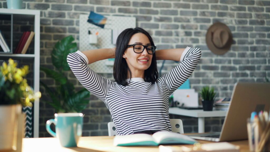 Professional woman taking a break from working at her laptop